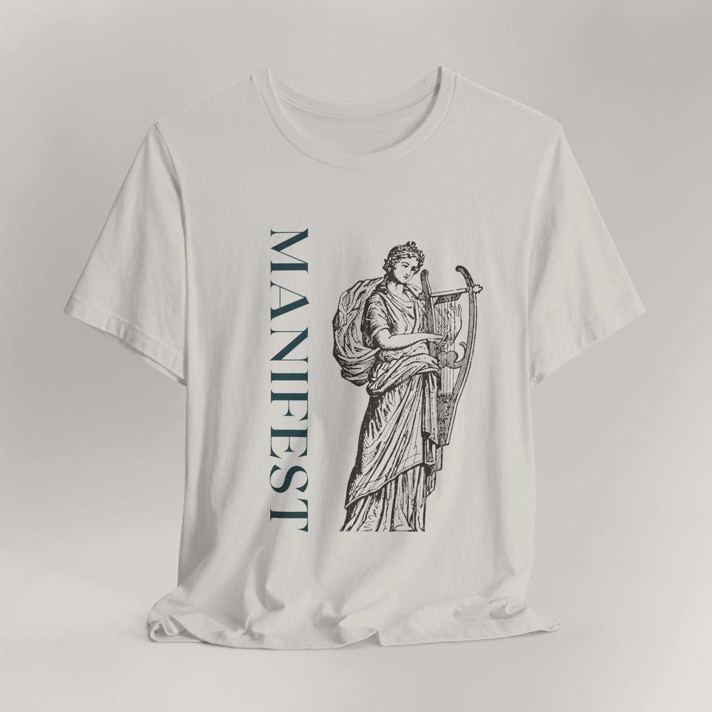 White t-shirt with 'MANIFEST' text and classical design on a gray background