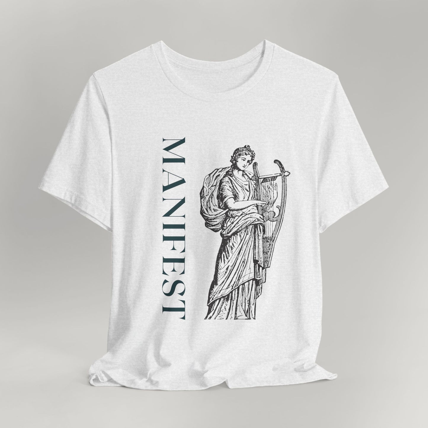 White t-shirt with black graphic design and 'MANIFEST' text on a gray background