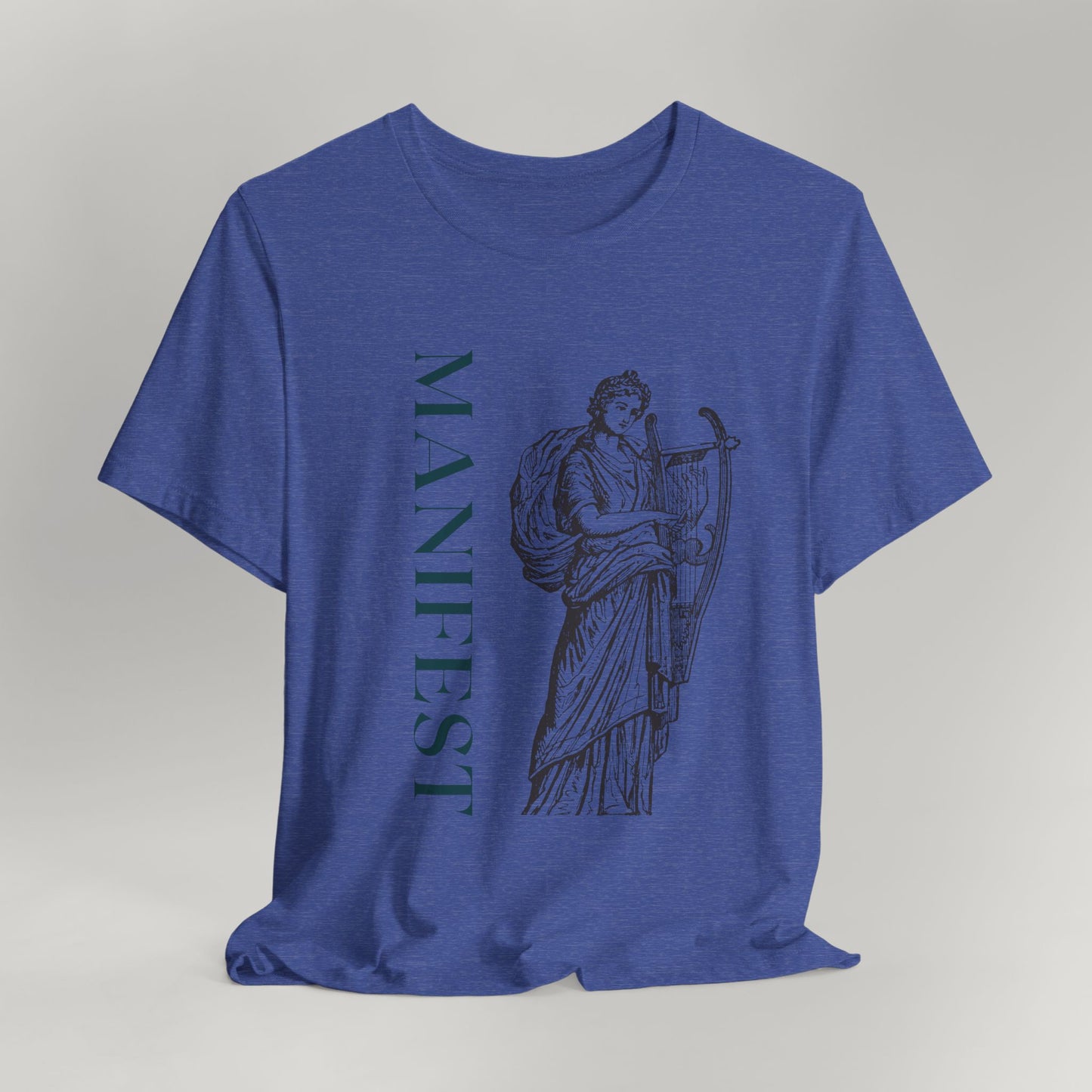 Blue t-shirt with a graphic design and 'MANIFEST' text on a gray background
